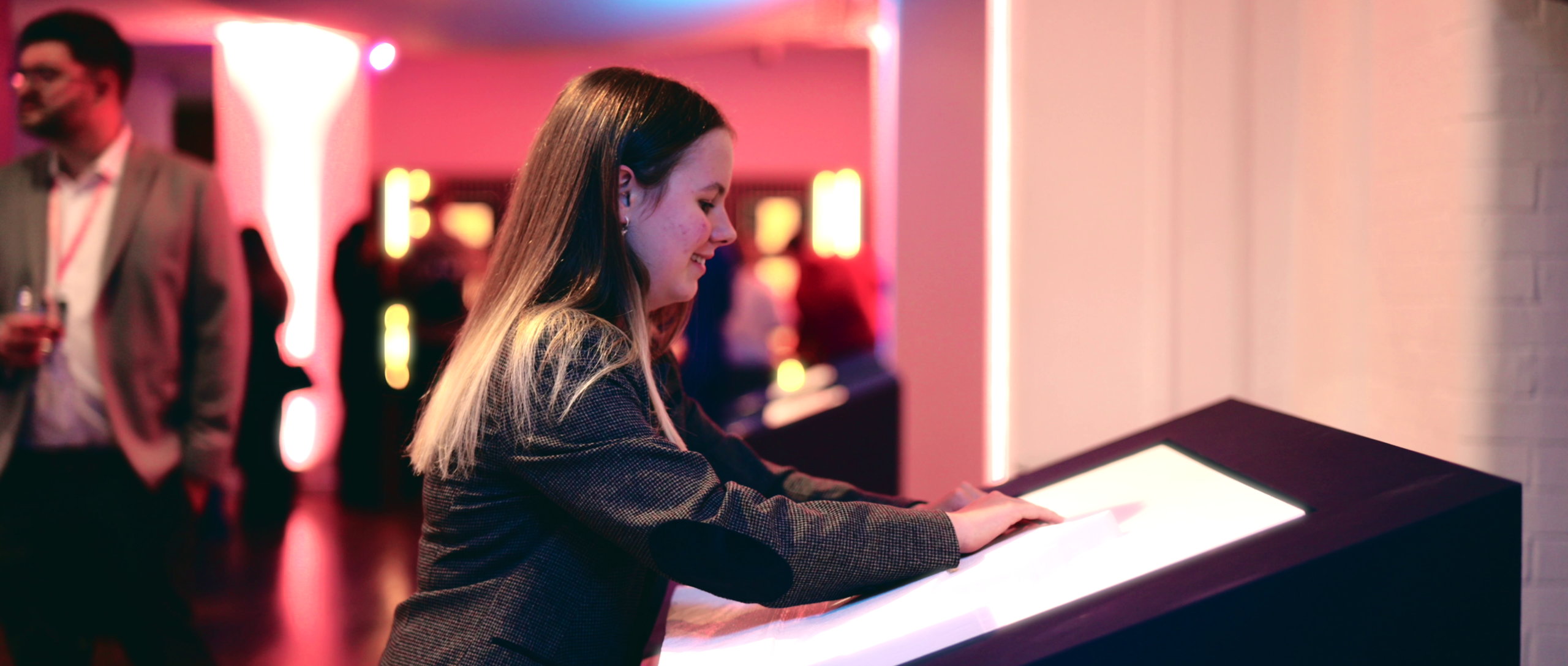 Attendees of the Touch: Beyond Vision exhibition experiencing the tactile artwork